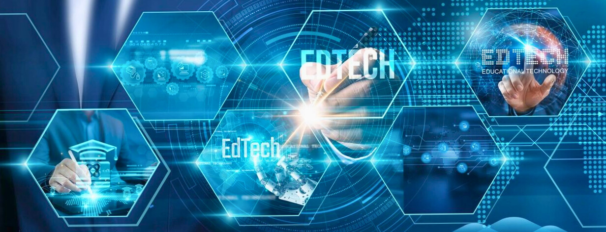 Abstract image of a human hand pressing on an area of a larger screen with few edtech labels.